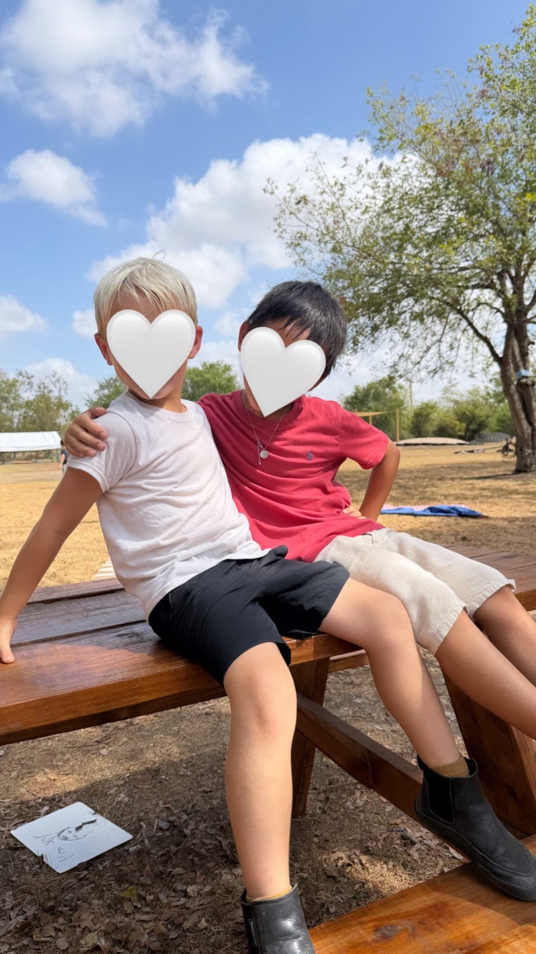 Friends together on the playground picnic table