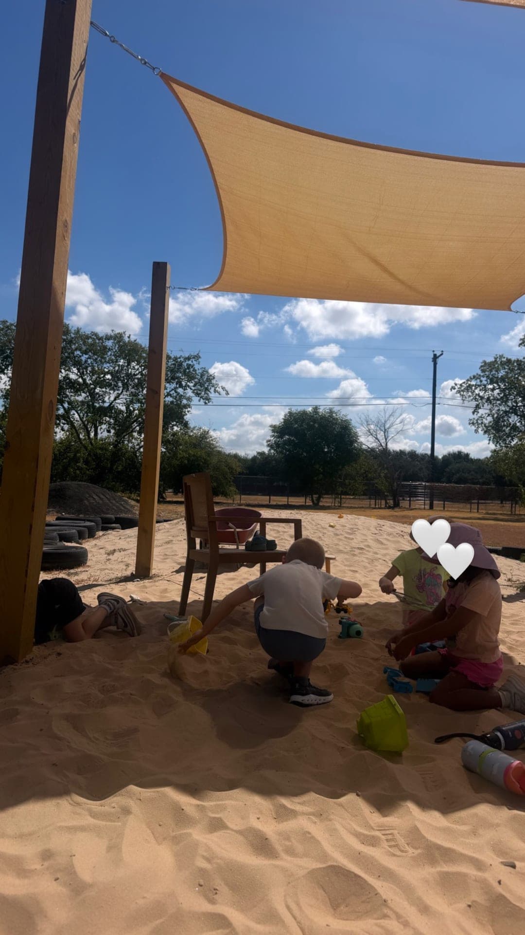 Sandbox play under the shade sail on a sunny afternoon