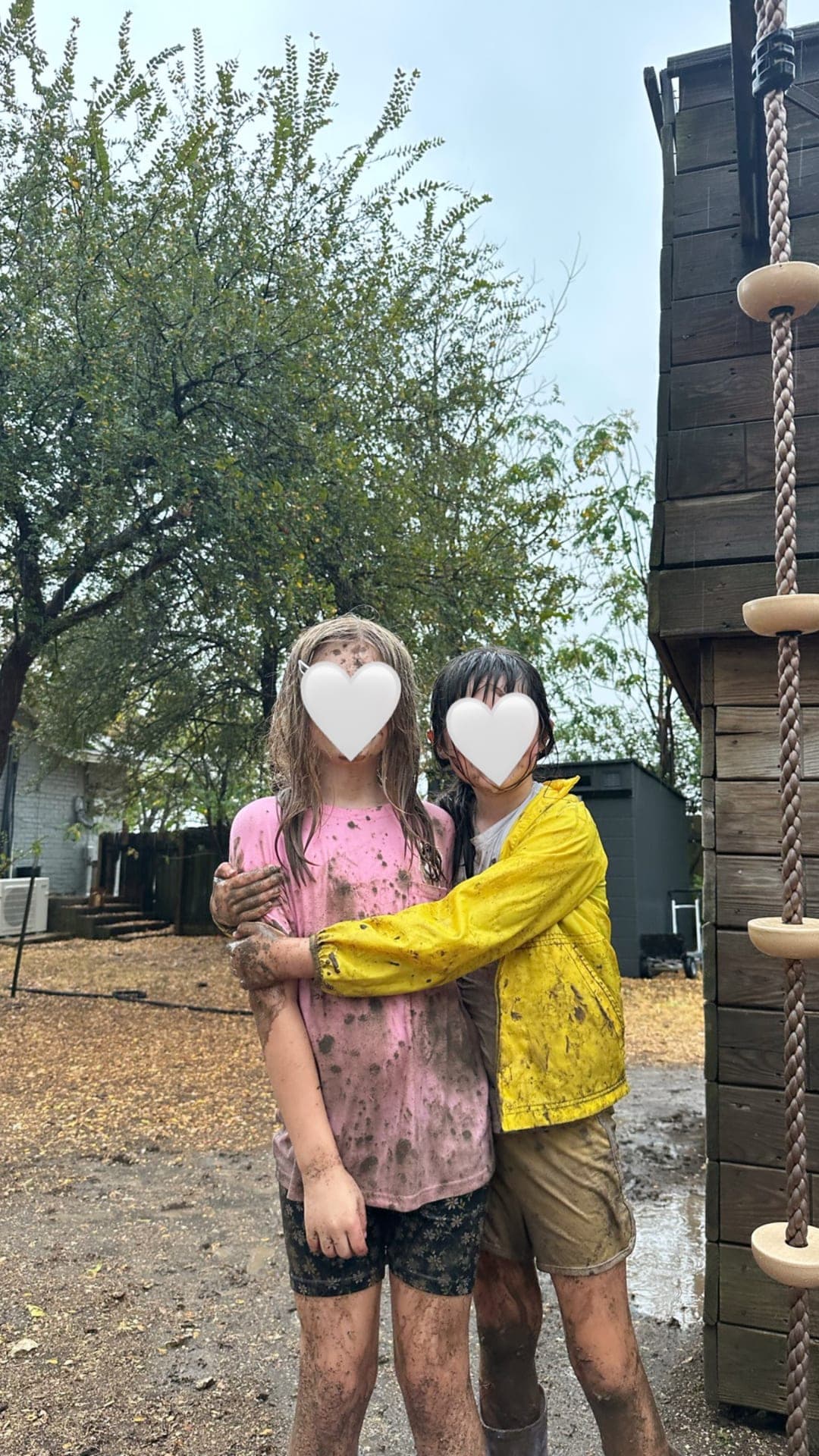 Friends embracing after messy outdoor sensory play