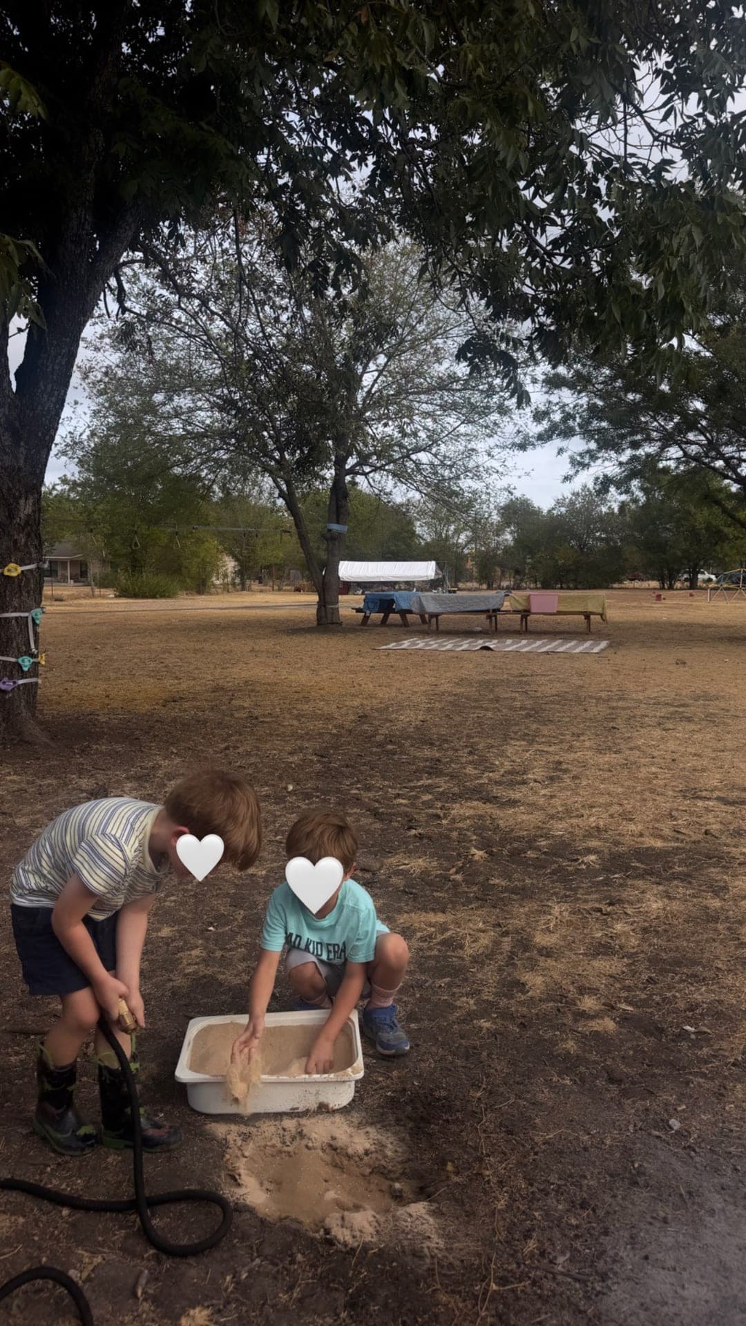 Sand-and-water exploration with a garden hose outdoors