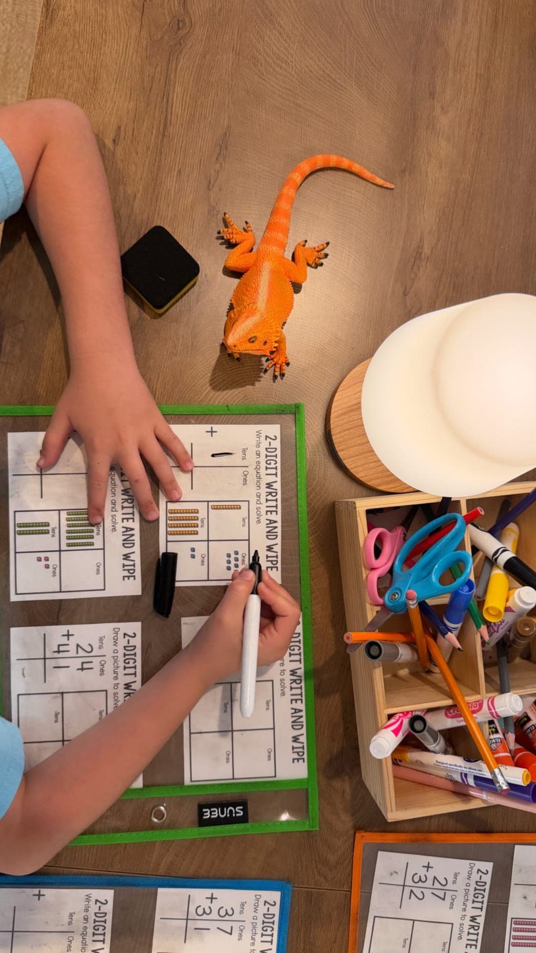 Lower elementary — two-digit addition with base-ten models on dry-erase sleeves