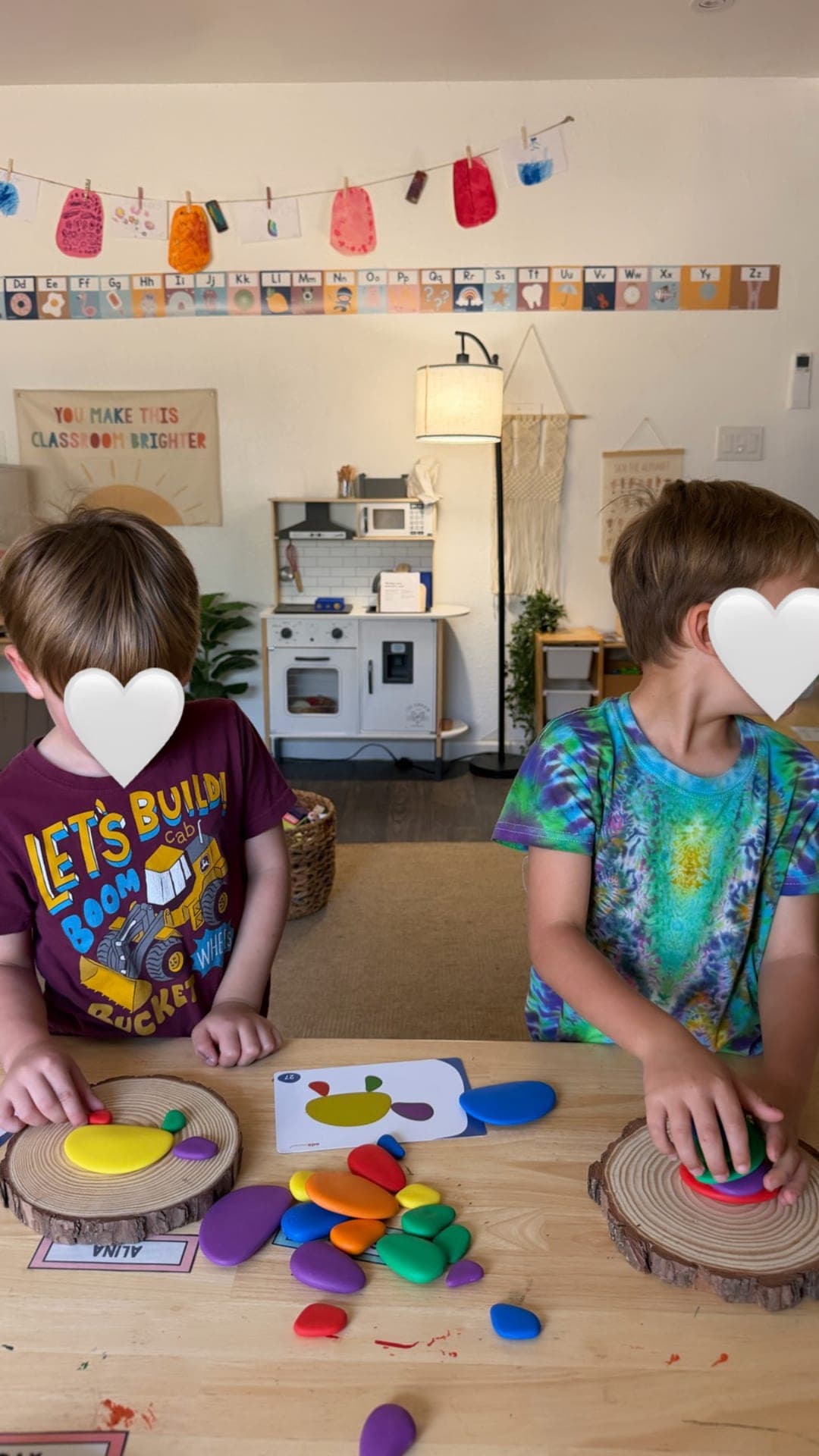 Primary — pattern-building with colorful pebbles and wooden slices