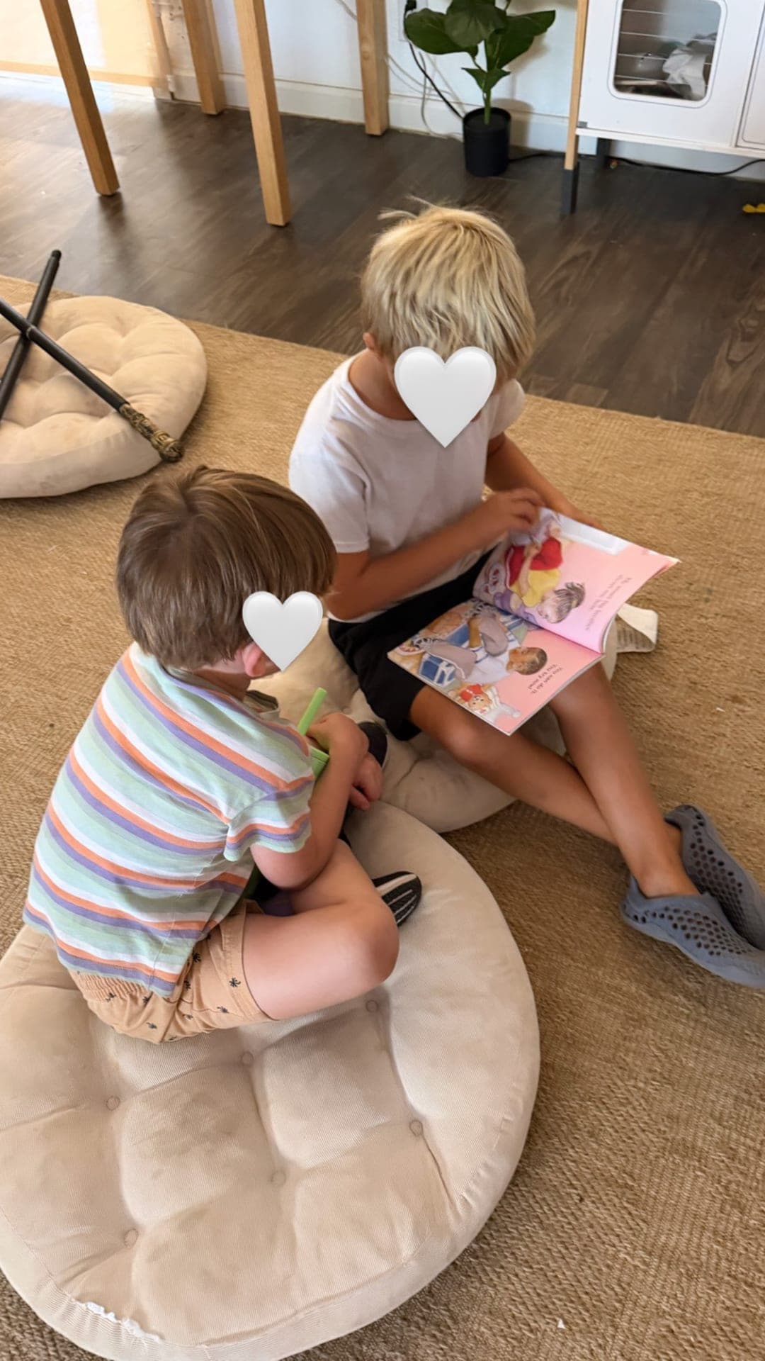 Friends sharing a picture book during quiet reading time