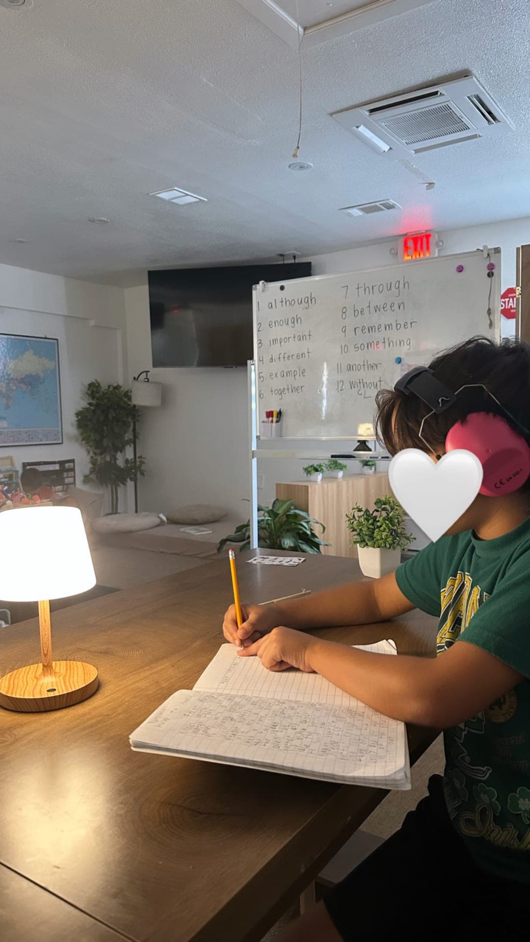 Upper elementary — focused vocabulary writing with headphones on