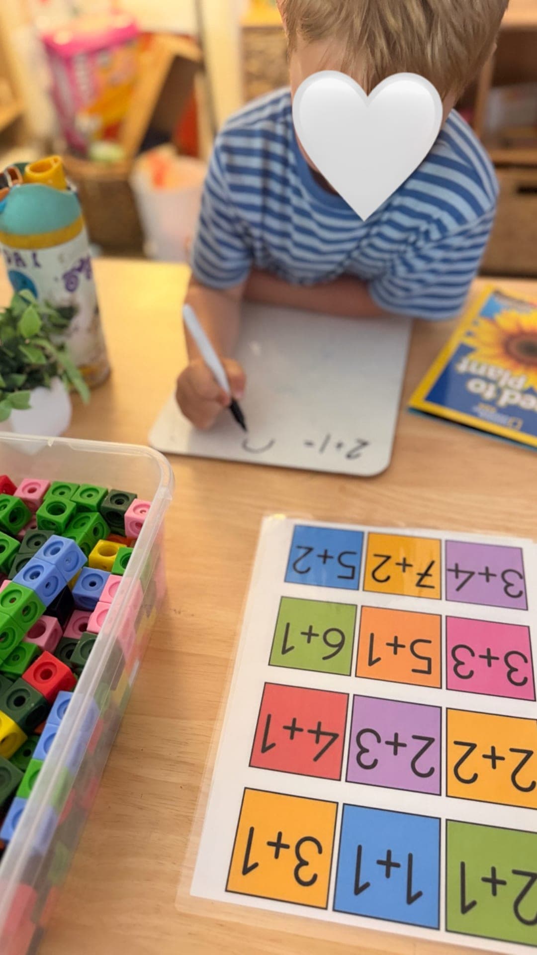 Addition practice with a color-block worksheet and whiteboard
