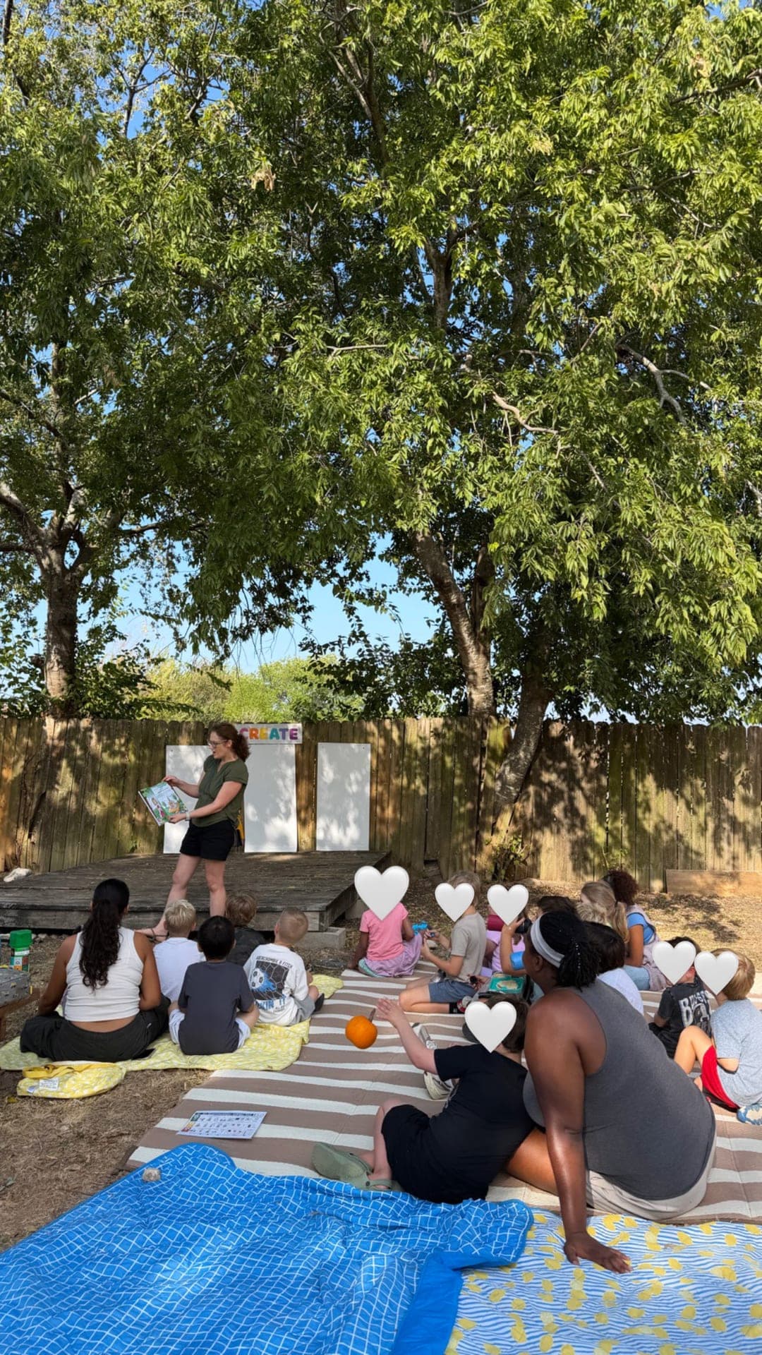 Outdoor storytime under the shade of the big trees