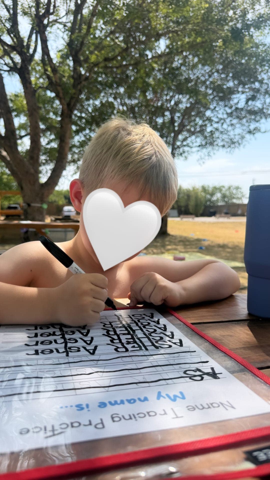 Name tracing practice at the outdoor picnic table
