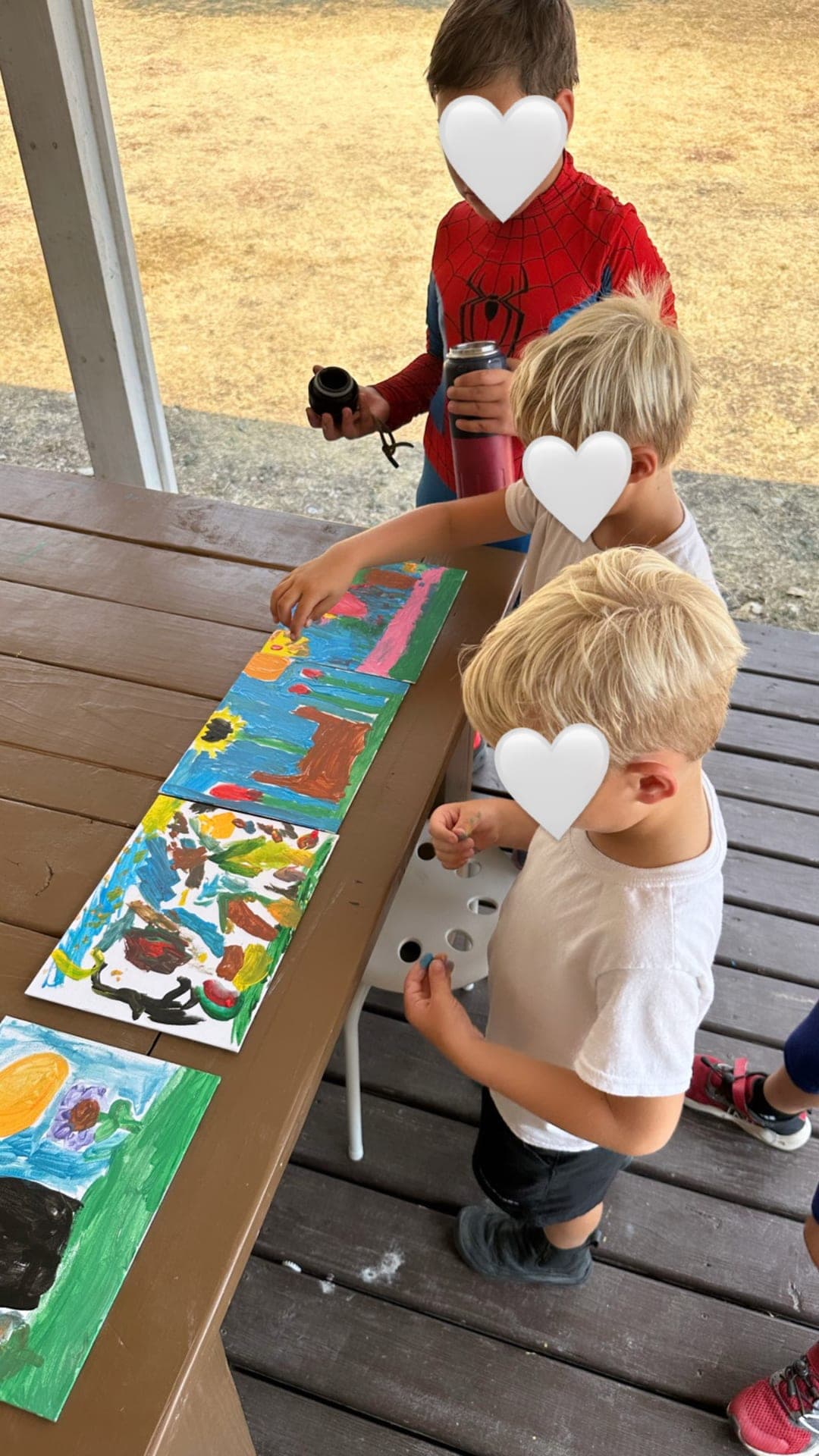 Nature-inspired garden paintings drying on the patio table