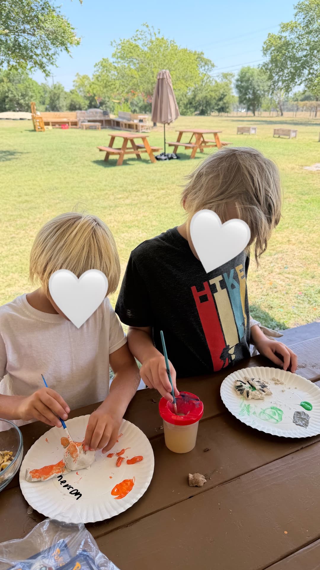 Painting clay sculptures at the picnic table — side-by-side creativity