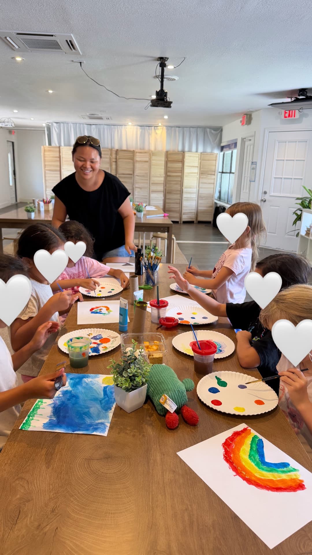 Rainbow painting around the table — Miss Joy cheering the whole group on