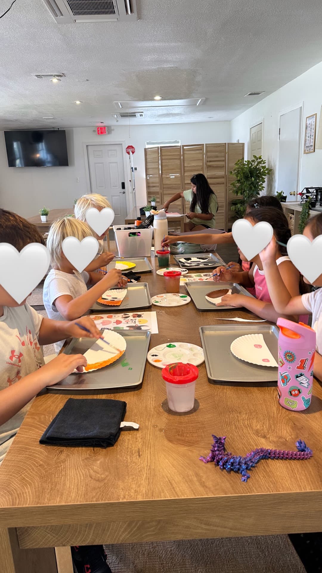Paper-plate painting on baking trays — focused, colorful, and collaborative