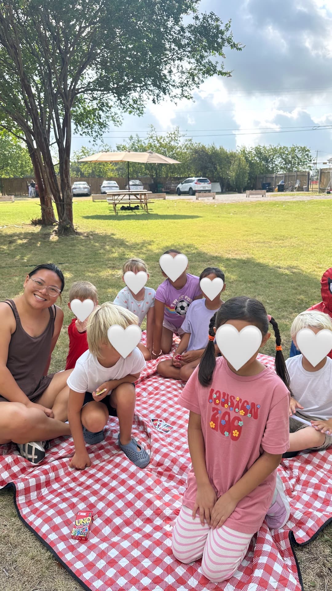 UNO on the checkered blanket — friendship building in the backyard
