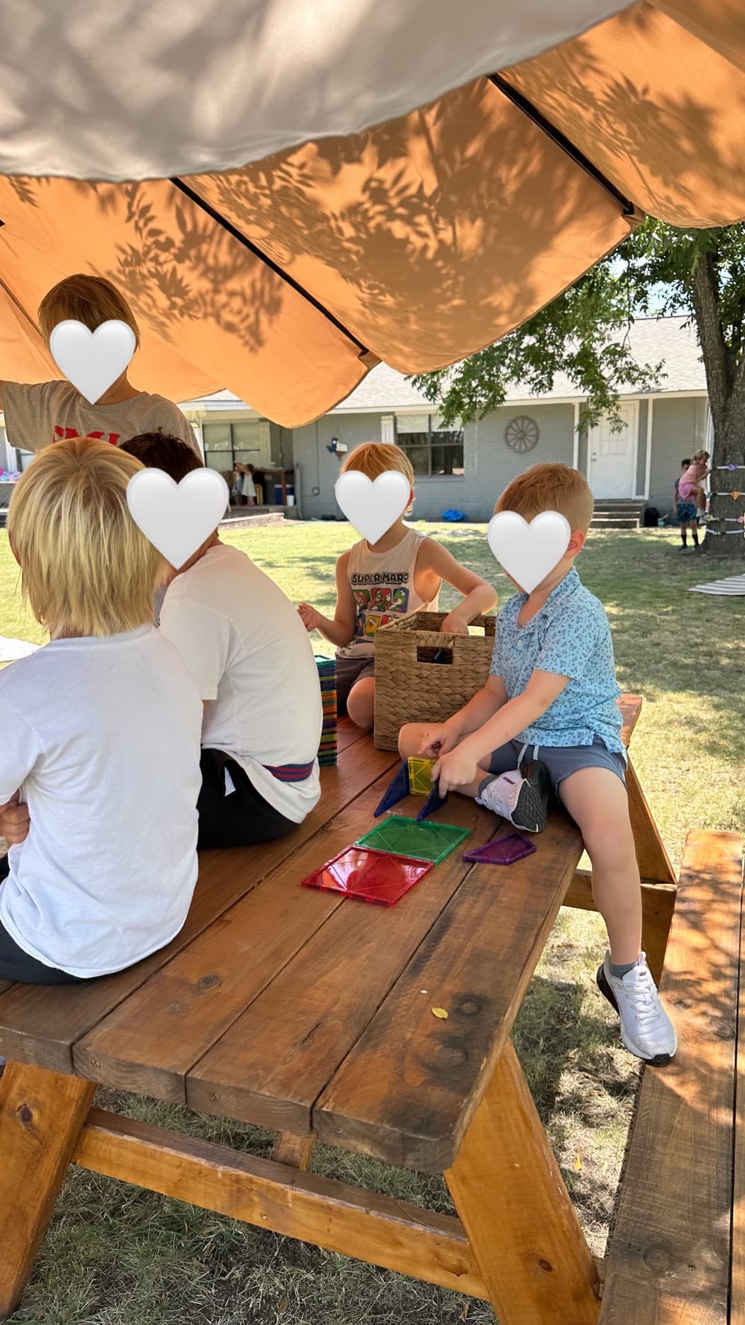 Magna-Tiles under the umbrella — cooperative play at the picnic table